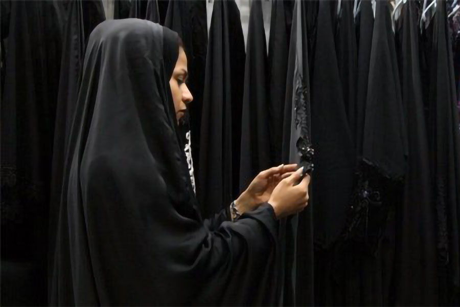 بانویی در حال بررسی چادرهای بازار